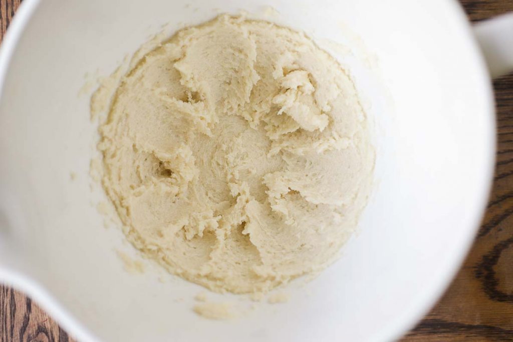 butter and sugar creamed together in a white stand mixer bowl