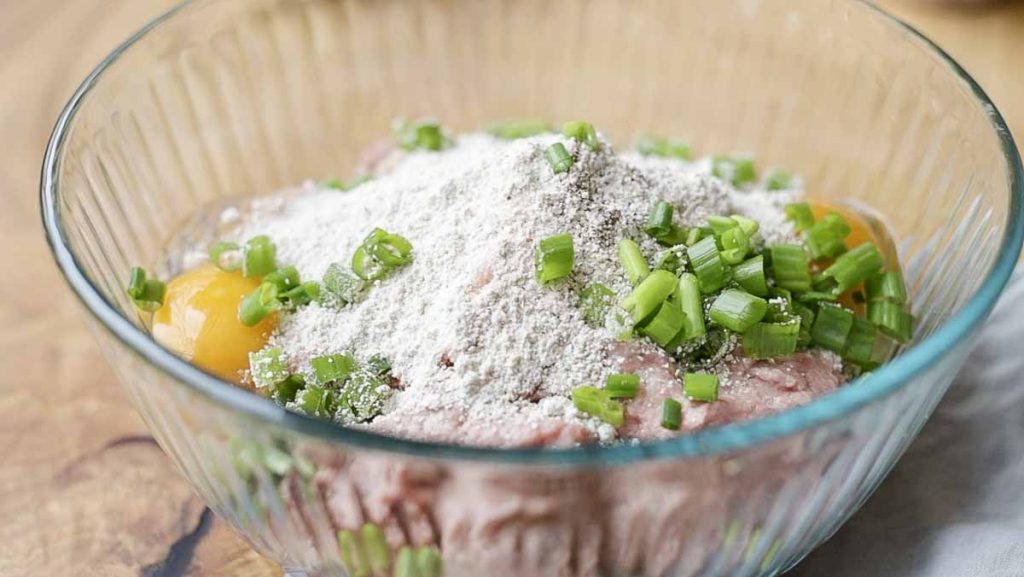 egg, oat flour, green onions, and ground turkey in a glass bowl