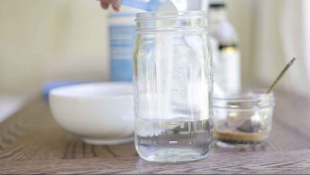 collagen peptides being added to a jar of water