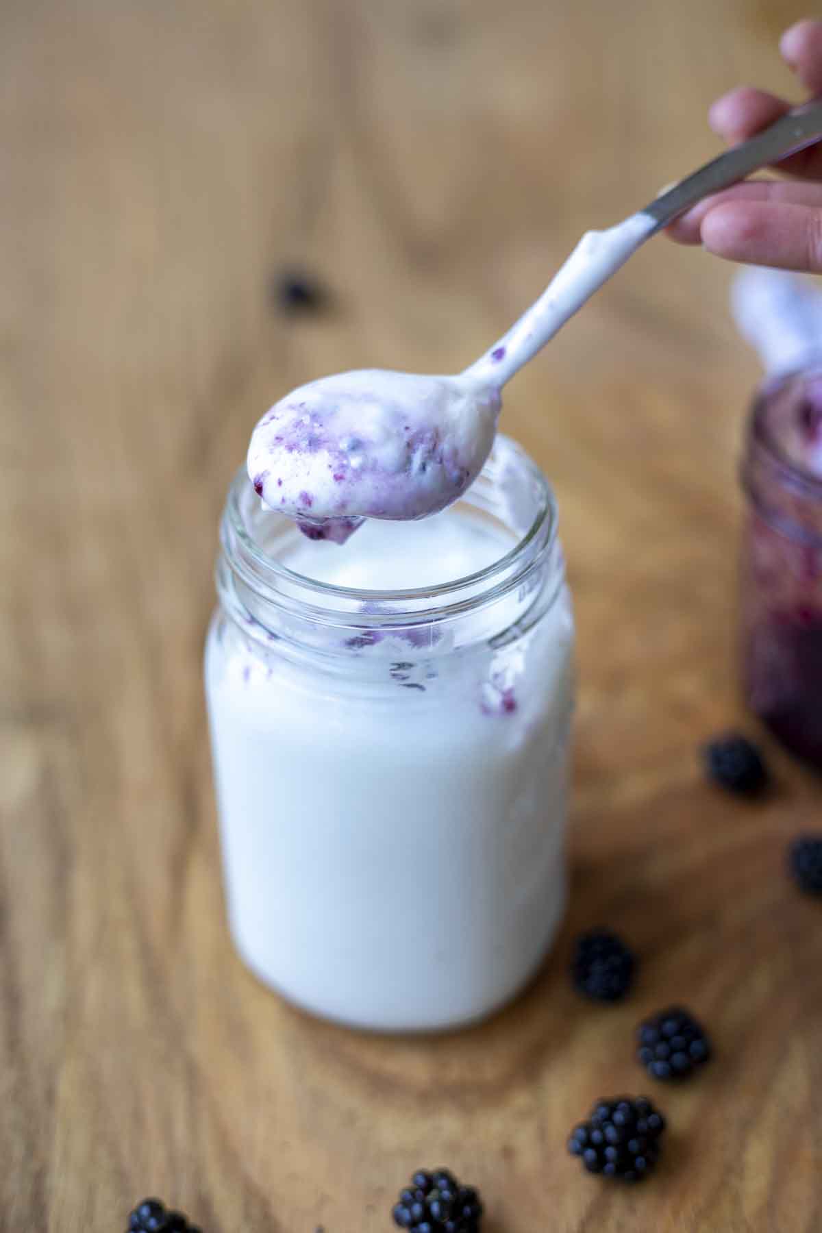 yogurt with spoon and blackberries